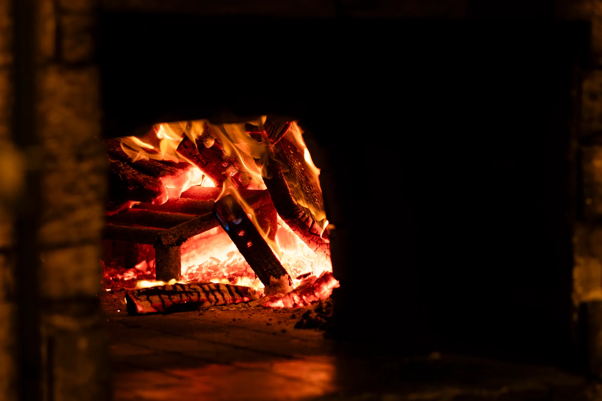 Logs burning inside the wood-fired oven